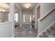 Inviting hallway with wood floors, neutral paint, and an open staircase at 1070 Gardenia Dr # 4, Mt Ulla, NC 28125