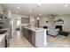 Open-concept kitchen showcases granite countertops, stainless steel appliances, and a seamless transition into the cozy living room at 1070 Gardenia Dr # 4, Mt Ulla, NC 28125