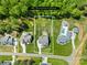 Aerial view of a property showcasing the .65 acre lot, surrounding trees, patio, and nearby houses at 108 Castleview Ln, Mooresville, NC 28115