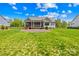 Beautiful backyard featuring a green lawn, a patio, and a charming screened porch at 108 Castleview Ln, Mooresville, NC 28115