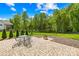 Outdoor patio features an elegant table and chairs set and a contemporary fire pit at 108 Castleview Ln, Mooresville, NC 28115