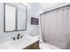 Bathroom with white quartz counters, dark wood vanity and shower/tub combination at 108 Castleview Ln, Mooresville, NC 28115