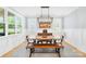 Dining room with large windows, modern chandelier, wainscoting, and hardwood floors at 108 Castleview Ln, Mooresville, NC 28115