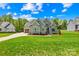 Landscaped home featuring lush greenery and a spacious driveway at 108 Castleview Ln, Mooresville, NC 28115