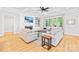 Cozy living room with a fireplace, built-in shelving, a large window, and hardwood floors at 108 Castleview Ln, Mooresville, NC 28115