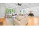 Open living room and dining area with hardwood floors, coffered ceilings, and large windows at 108 Castleview Ln, Mooresville, NC 28115