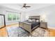 Spacious main bedroom with hardwood floors, large window, and neutral paint scheme at 108 Castleview Ln, Mooresville, NC 28115