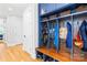 Inviting mudroom featuring custom blue cabinetry, coat hooks, and bench seating with shoe storage at 108 Castleview Ln, Mooresville, NC 28115