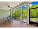 Relaxing screened porch with wooden floors, a ceiling fan, and a peaceful view of the outdoors at 108 Castleview Ln, Mooresville, NC 28115