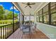 Cozy screened-in porch with a table, chairs, and a view of the backyard and neighboring home at 108 Castleview Ln, Mooresville, NC 28115