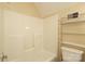 Bright bathroom with a shower/tub combo, and storage shelves at 1121 Thoroughbred Nw Pl, Concord, NC 28027
