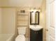 Bathroom featuring a single sink vanity, toilet, and shower/tub combo with shelving for storage at 1121 Thoroughbred Nw Pl, Concord, NC 28027