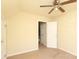 Bright bedroom with a ceiling fan, carpet flooring, and two closets at 1121 Thoroughbred Nw Pl, Concord, NC 28027