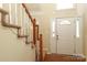 Front entryway with staircase, carpeted steps, and natural light, providing a welcoming entrance at 1121 Thoroughbred Nw Pl, Concord, NC 28027