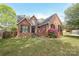Inviting brick home featuring a well-manicured lawn and classic architectural details, perfect for families at 1121 Thoroughbred Nw Pl, Concord, NC 28027