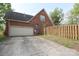 Detached two-car garage with an adjacent wooden fence providing privacy and security at 1121 Thoroughbred Nw Pl, Concord, NC 28027