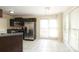 Bright kitchen with stainless steel refrigerator and tile flooring at 1121 Thoroughbred Nw Pl, Concord, NC 28027