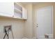 Laundry room with overhead cabinets and white door at 1121 Thoroughbred Nw Pl, Concord, NC 28027