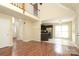Spacious living room featuring hardwood floors and an open floor plan leading into the kitchen area at 1121 Thoroughbred Nw Pl, Concord, NC 28027