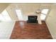 Open living room featuring hardwood floors, a ceiling fan, and a black fireplace at 1121 Thoroughbred Nw Pl, Concord, NC 28027