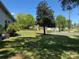 A tranquil backyard featuring a mature tree and ample green space, perfect for outdoor activities and relaxation at 1203 N Charlotte Ave, Monroe, NC 28110