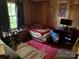 Bedroom with wood paneling, a bright window, and a sports jersey hanging on the wall at 1203 N Charlotte Ave, Monroe, NC 28110