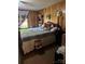 Bedroom with a large bed, paneled walls, and a window with floral curtains at 1203 N Charlotte Ave, Monroe, NC 28110