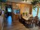 Dining area featuring wood paneled walls, a table set for six, and access to the kitchen at 1203 N Charlotte Ave, Monroe, NC 28110