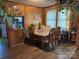 Classic dining room with wood paneled walls, hardwood floors, and a six-chair dining set at 1203 N Charlotte Ave, Monroe, NC 28110