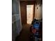 Hallway leading to a bathroom with floral shower curtain and storage space at 1203 N Charlotte Ave, Monroe, NC 28110