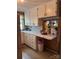 Kitchen view with white cabinets, patterned backsplash, and a serving counter to the dining room at 1203 N Charlotte Ave, Monroe, NC 28110