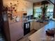 Classic kitchen with a pink refrigerator, black stove, white cabinets, and sunny window at 1203 N Charlotte Ave, Monroe, NC 28110