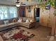 Cozy living room featuring comfortable seating, a ceiling fan, and warm wood paneling creating a welcoming atmosphere at 1203 N Charlotte Ave, Monroe, NC 28110