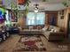 Inviting living room with cozy furniture, wood paneling, and natural light creating a comfortable and warm atmosphere at 1203 N Charlotte Ave, Monroe, NC 28110