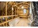 Unfinished attic space showcasing wooden beams and a window, ready for customization at 124 Rosebay Dr, Mooresville, NC 28117
