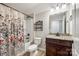 Functional bathroom with vanity, floral shower curtain, and neutral tones provides comfort and convenience at 124 Rosebay Dr, Mooresville, NC 28117