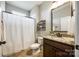 Bathroom featuring granite countertop, modern vanity, toilet and a shower behind a white curtain at 124 Rosebay Dr, Mooresville, NC 28117