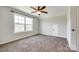 Cozy bedroom with carpet, a bright window, and white trim offers a simple yet stylish space at 124 Rosebay Dr, Mooresville, NC 28117