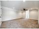 Spacious bedroom boasts neutral carpeting and ceiling fan, offering a tranquil retreat at 124 Rosebay Dr, Mooresville, NC 28117