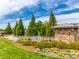 Stone community entrance featuring a water feature, lush landscaping, and pristine lawn at 124 Rosebay Dr, Mooresville, NC 28117