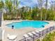 A well-maintained community pool surrounded by lounge chairs and ample seating at 124 Rosebay Dr, Mooresville, NC 28117