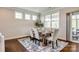 Dining area with a wooden table set, neutral colors, and plenty of natural light at 124 Rosebay Dr, Mooresville, NC 28117