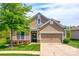 Charming two-story home with a well-manicured lawn, featuring a two-car garage and a lovely front yard at 124 Rosebay Dr, Mooresville, NC 28117