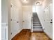 Bright foyer featuring hardwood floors, crisp white trim, and a staircase with carpeted steps at 124 Rosebay Dr, Mooresville, NC 28117