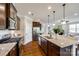 Modern kitchen with stainless steel appliances, granite countertops, and a large island with seating at 124 Rosebay Dr, Mooresville, NC 28117