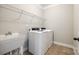 Laundry room featuring a sink, washer, dryer, tile floor and white walls at 124 Rosebay Dr, Mooresville, NC 28117