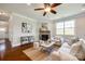 Comfortable living room showcasing a stone fireplace, hardwood floors, and ample seating at 124 Rosebay Dr, Mooresville, NC 28117