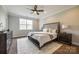 Spacious main bedroom with a ceiling fan, carpeted floor, a large window, and neutral walls at 124 Rosebay Dr, Mooresville, NC 28117