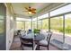 Enclosed sunroom with ceiling fan, round table and chairs, and sliding glass doors that open to the backyard at 124 Rosebay Dr, Mooresville, NC 28117