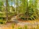 A scenic walking trail winding through a lush, wooded area at 124 Rosebay Dr, Mooresville, NC 28117